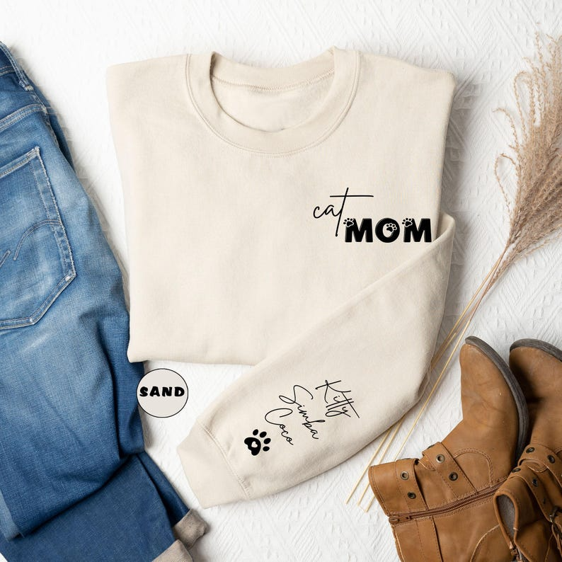Custom Cat Mom Sweatshirt With Pets Names On Sleeve, Personalized Cat Mama Hoodie, Cat Lover Outfit, Mom Of Cat Clothing, Mothers Day Gifts