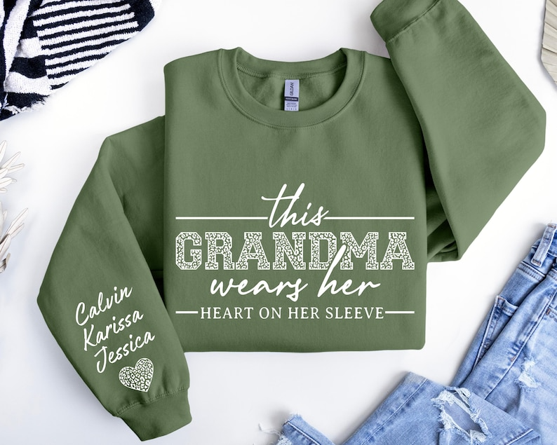 Custom Grandma Sweatshirt, This Grandma Wears Her Heart On Her Sleeve Sweater, With Kids Name On Sleeve, Grandma Sweater,Custom Grandma Gift