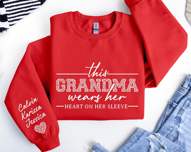 Custom Grandma Sweatshirt, This Grandma Wears Her Heart On Her Sleeve Sweater, With Kids Name On Sleeve, Grandma Sweater,Custom Grandma Gift