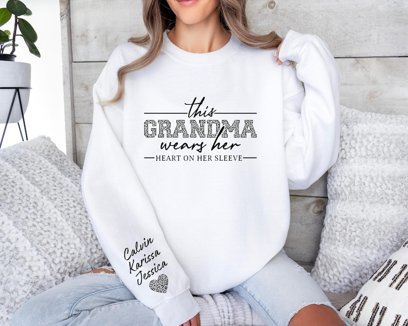 Custom Grandma Sweatshirt, This Grandma Wears Her Heart On Her Sleeve Sweater, With Kids Name On Sleeve, Grandma Sweater,Custom Grandma Gift