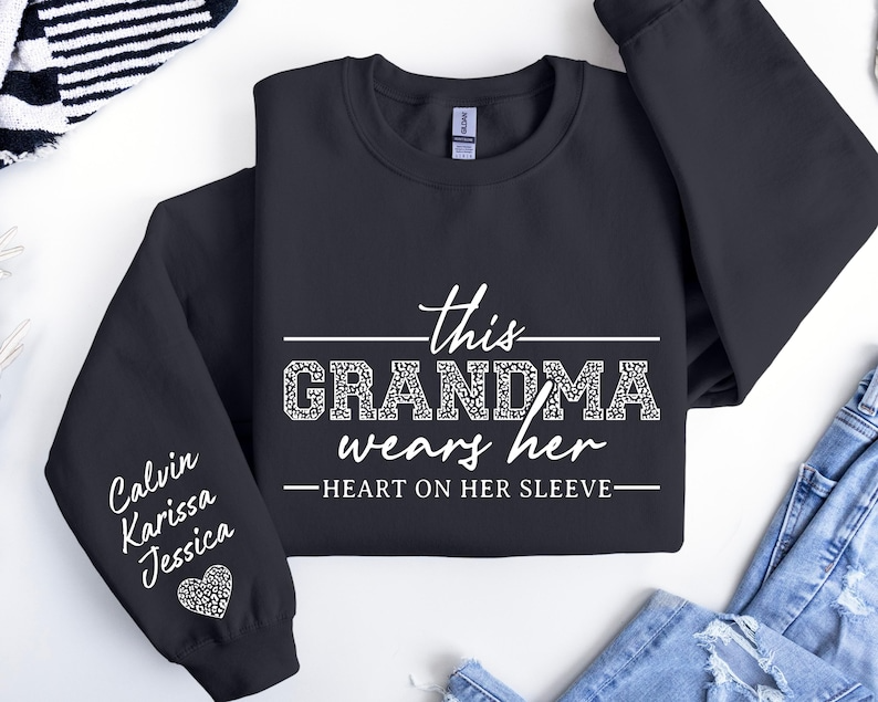 Custom Grandma Sweatshirt, This Grandma Wears Her Heart On Her Sleeve Sweater, With Kids Name On Sleeve, Grandma Sweater,Custom Grandma Gift