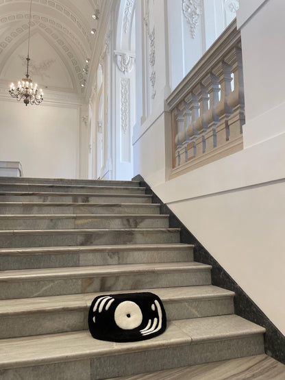 An aesthetic "vinyl record" rug made using the tufting method